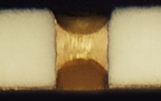 Cross section of polyimide filled via in a thin film substrate